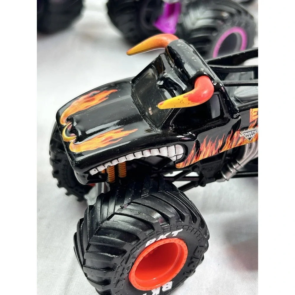 Lot Of 4 Diecast Monster Trucks 3 Hot wheels El Toro Grave Digger Rattlesnake